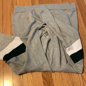Grey hoodie with green/white accents.